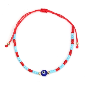 Close-up of handmade red braided evil eye bracelet with colorful beads and adjustable cord