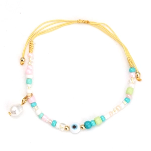 Detail of adjustable evil eye bracelet with colorful beads and a pearl pendant charm