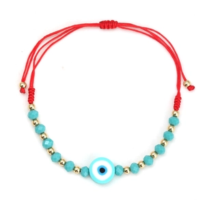 Detail view of red woven Evil Eye bracelet with blue faceted beads and gold accents