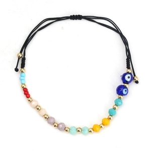 Detail view of handmade black string bracelet with evil eye beads and colorful charms