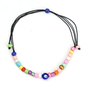 Detailed view of handmade Evil Eye charm bracelet with colorful beads and black cord