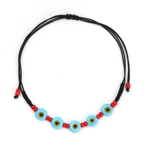 Detail view of light blue Evil Eye beads and red spacer beads on black woven cord