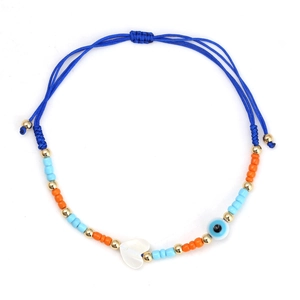 Detailed view of adjustable evil eye bracelet with red beads and white heart charm