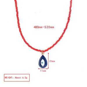 Detail view of red beaded necklace with blue evil eye pendant showing size measurements