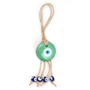 Detail of green Evil Eye glass charm with braided hemp rope and small blue beads