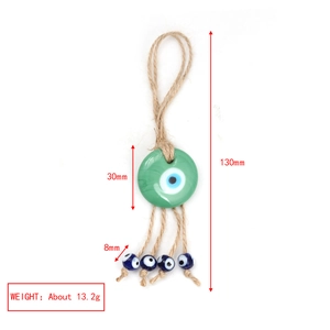 Green glass evil eye keychain charm with braided rope and measurements shown
