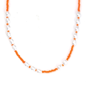 Detail of orange seed beads and white baroque pearls on a handmade beaded necklace