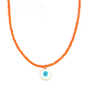 Detail of orange seed beads and a blue enamel evil eye charm on a gold necklace