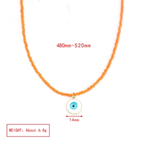 Detail showing orange beaded necklace with 14mm evil eye pendant and size dimensions