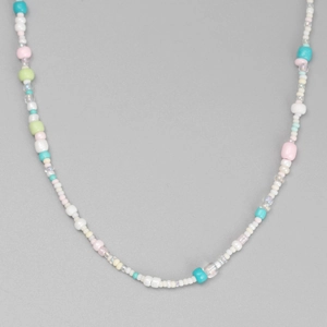 Detail shot of colorful beaded necklace with mint, pink and yellow resin beads
