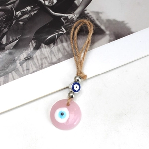 Pink evil eye keychain with braided hemp rope and polished metallic beads detail