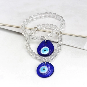 Detail of beaded evil eye keychains with transparent glass beads and blue eye charms