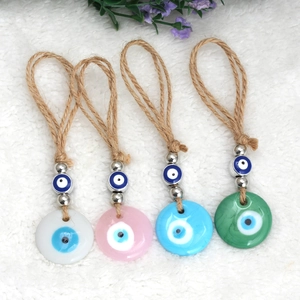 Detailed set of four colored glass evil eye pendants with natural jute rope hangers