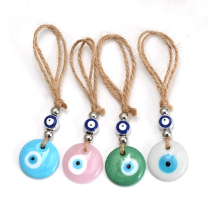 Evil Eye decorative charms with hemp rope hangers in blue, pink, green, and white
