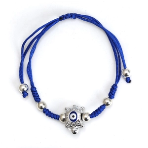 Detail of royal blue woven cord bracelet with silver turtle charm and evil eye bead