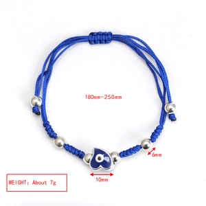 Detail of adjustable blue braided bracelet with silver beads and 10mm evil eye heart charm