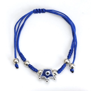Macro detail of hand-woven blue cord bracelet with Evil Eye charm and silver beads