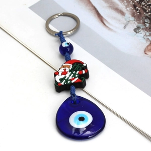 Detail of Christmas Evil Eye keychain with Santa Claus pendant and blue glass charm