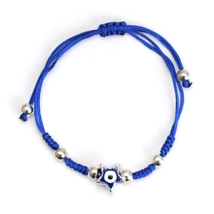 Detailed macro of a blue woven bracelet featuring a star-shaped Evil Eye pendant and silver beads
