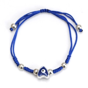 Detail of hand-woven blue cord bracelet featuring silver beads and evil eye heart charm