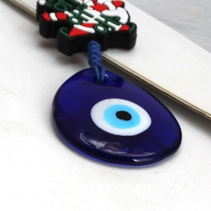 Detailed macro view of festive Evil Eye glass charm with Ho Ho holiday decoration