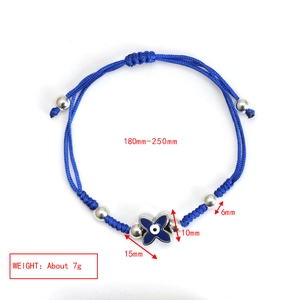 Detail showing adjustable blue braided rope bracelet with silver beads and evil eye charm