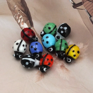 Macro shot of colorful glass ladybug beads for DIY handmade jewelry making