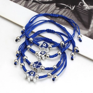 Set of four blue woven Evil Eye bracelets with heart, elephant and star charms