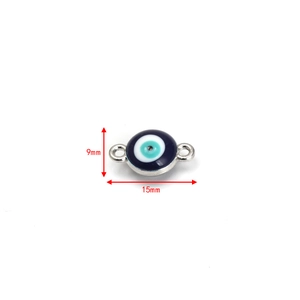 Detail of 15mm evil eye charm with blue enamel inlay and dual connector rings
