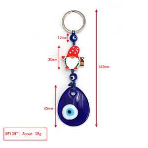Detail view of Evil Eye and gnome keychain with size measurements and weight about 38g