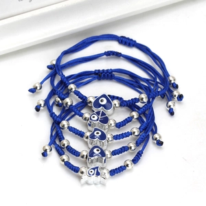 Detail of 5-piece evil eye braided cord bracelets with blue heart-shaped enamel charms