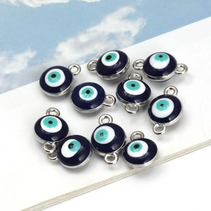 Macro detail of blue evil eye enamel charms with silver metal edges for DIY jewelry making