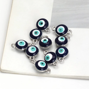 Close-up of blue evil eye charms with silver frames for DIY jewelry making