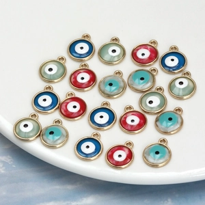Macro shot of colorful round evil eye charms with gold plated alloy base for DIY jewelry