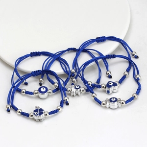 5-piece set of blue woven Evil Eye bracelets with silver charms and adjustable knots