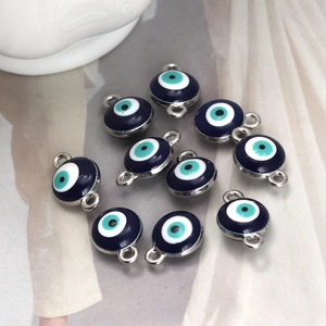 Macro detail of deep blue enamel evil eye connectors with silver loops for DIY jewelry
