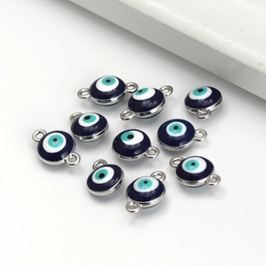 Macro detail of blue Evil Eye enamel charms with silver plating for DIY jewelry making