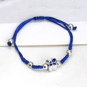 Detail of blue braided rope bracelet with silver butterfly evil eye charm and metal beads
