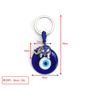 Detail view of evil eye glass disk keychain with silver elephant pendant and measurements