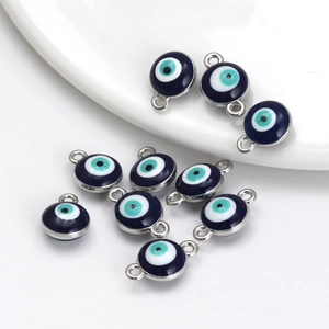 Detail of blue evil eye charms with silver metal borders for DIY jewelry making