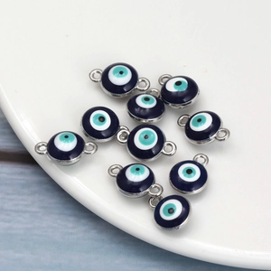 Detail of round evil eye pendants and connectors in blue enamel and silver metal