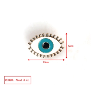 Detail of evil eye brooch showing measurements 25mm width and 12mm height on gold base