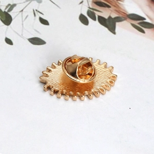 Detail view of the gold-plated alloy brooch back featuring a butterfly clutch fastener