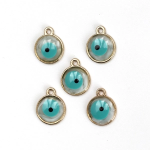 Detailed view of five blue evil eye charms with golden frames for jewelry making