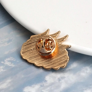 Detailed back view of gold-tone alloy brooch featuring a butterfly clutch and pin fastener