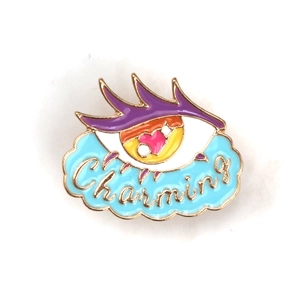 Detailed close-up of a charming purple eye enamel brooch with crystal accents and cloud