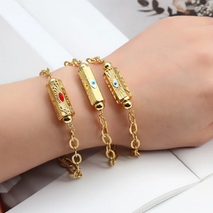 Detailed view of three gold-plated Evil Eye bracelets with enamel charms and crystal accents