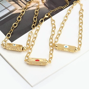 Detail of adjustable gold-plated necklaces with devil's eye and wild engraved pendants