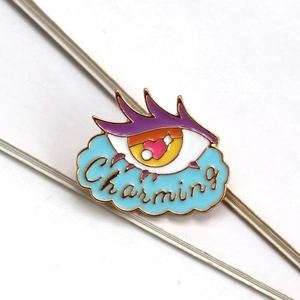 Charming enamel eye brooch with purple eyelashes and yellow pupil on light blue cloud