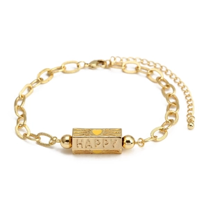 Detailed macro view of gold chain bracelet with HAPPY engraved rectangular link and heart
